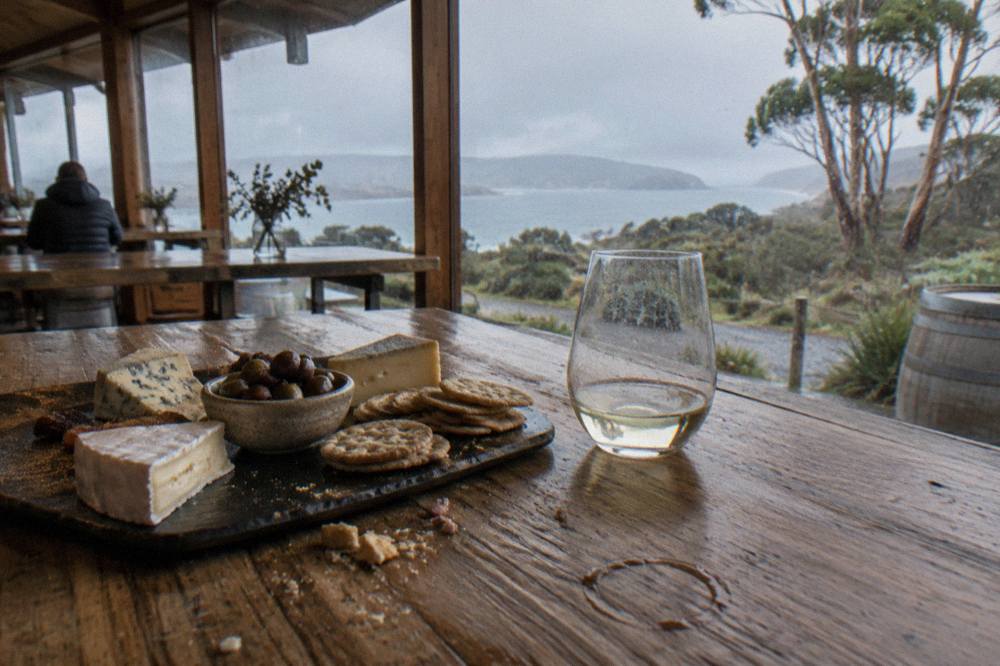 A platter of cheese, olives and crackers on a timber cellar door counter
