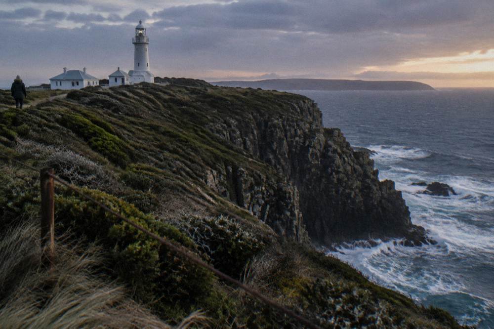 Tall sea cliffs rising from open ocean along a rugged island coastline