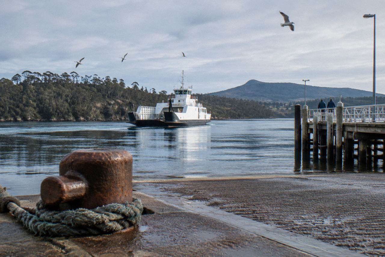 Vehicle ferry approaching the Kettering terminal ramp across calm water