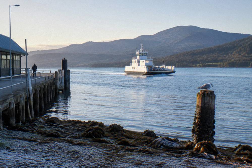 The Bruny Island ferry underway on the DEntrecasteaux Channel with forested hills behind