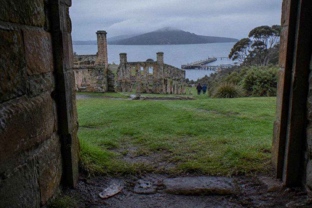 Sandstone ruins of a historic convict site standing on a green headland